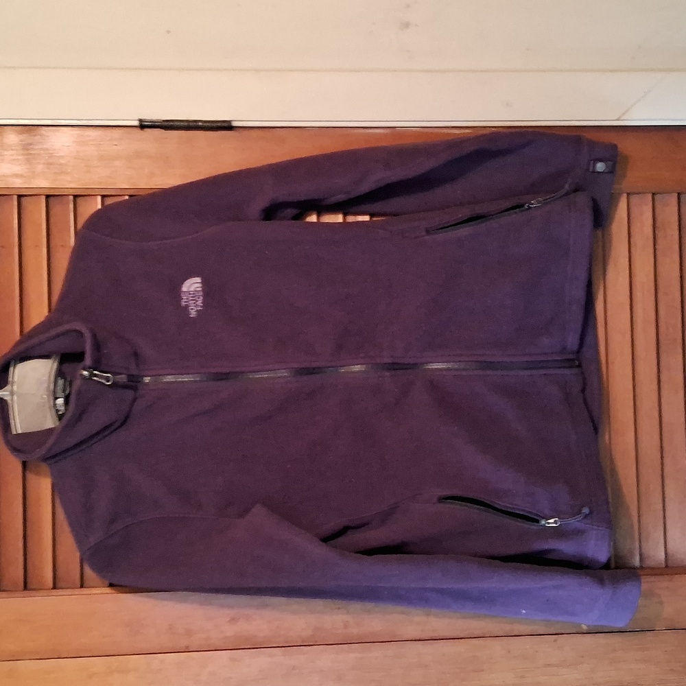 The North Face women's size small purple zip-up fleece jacket.